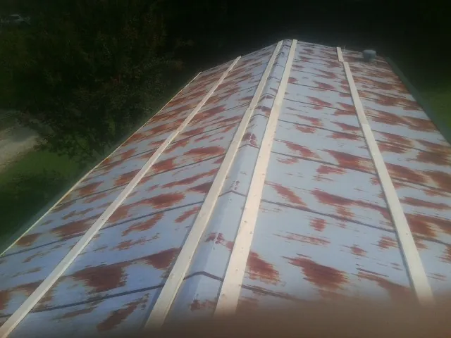 Rusted metal roof panels with new wood purlins before replacement — Storm Damage Roof Repair in Parris Island by Roofing Brothers