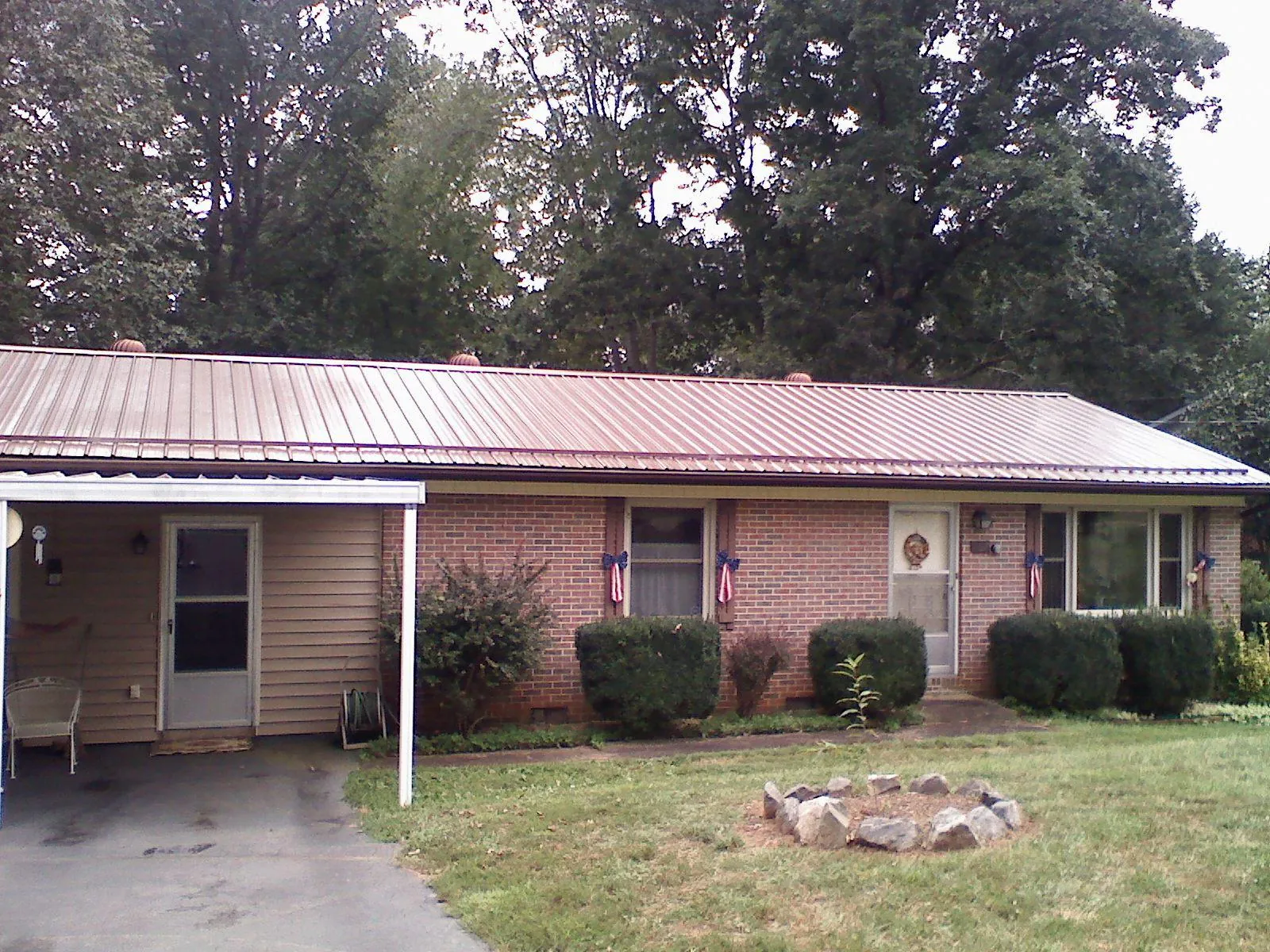 Bronze metal roof and carport on a brick ranch home — Roof Repair work by our crew in Parris Island