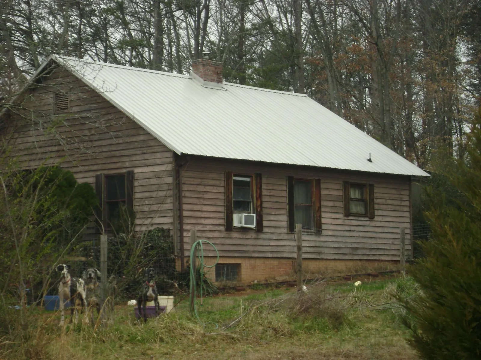 White metal roof on an old wood sided farmhouse, from a Metal Roof Installation job in Parris Island